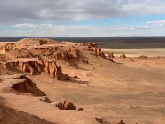 The red sandstone cliffs of Bayanzag above the Gobi plain