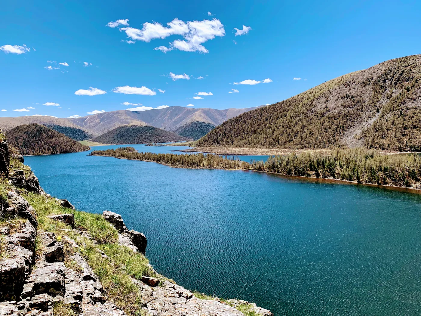 A turquoise lake held between steep ridges