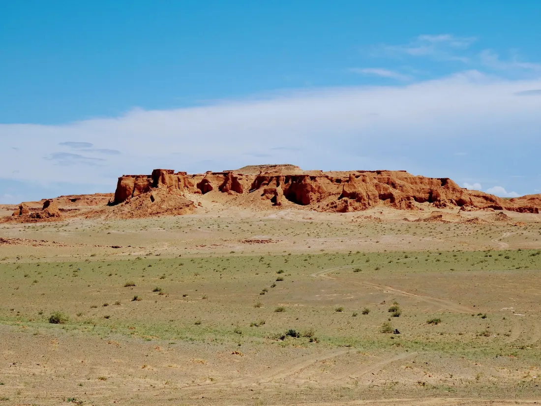 A red rock escarpment on a gravel plain