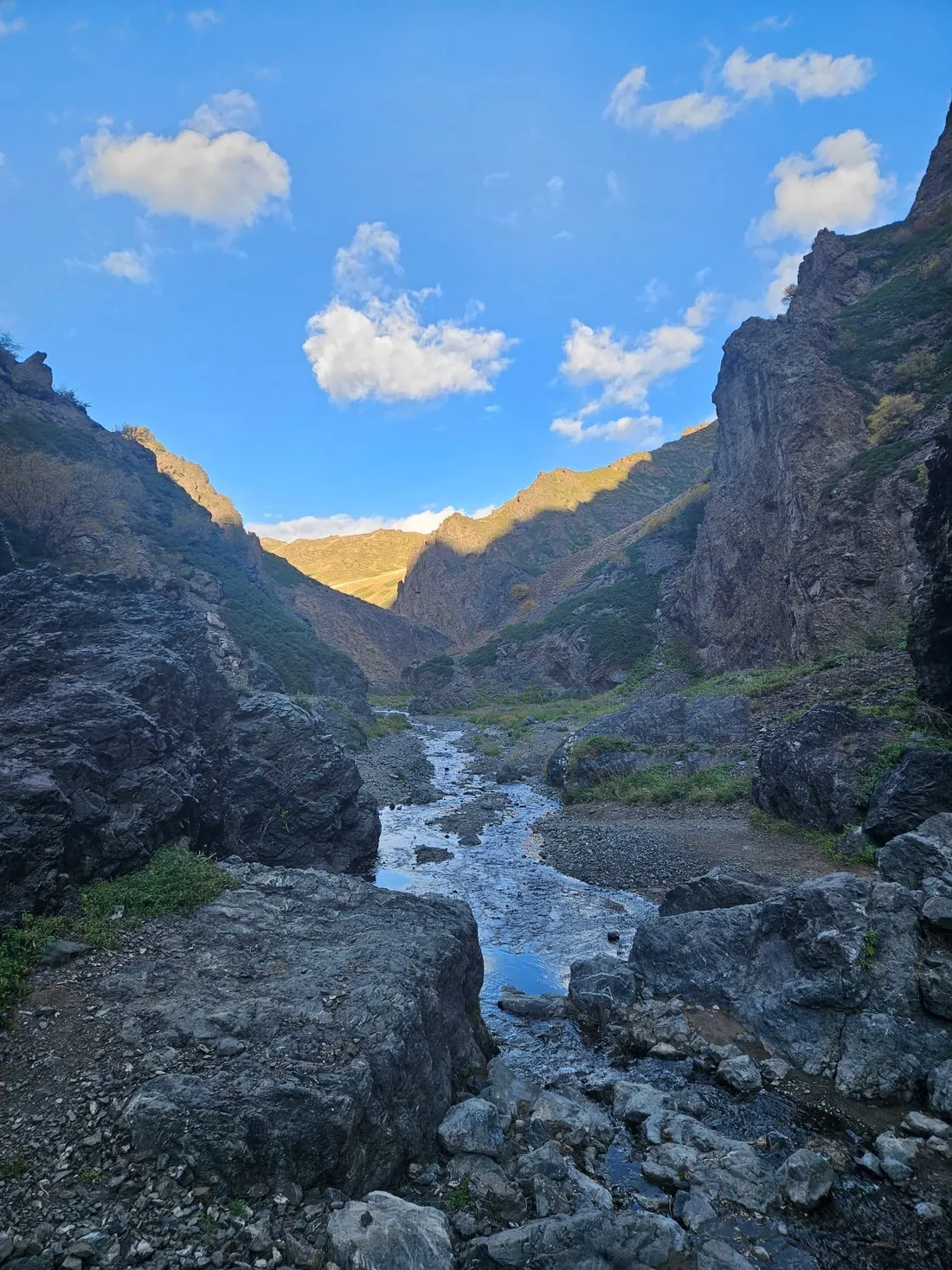 A stream running between dark rocks through a narrow gorge